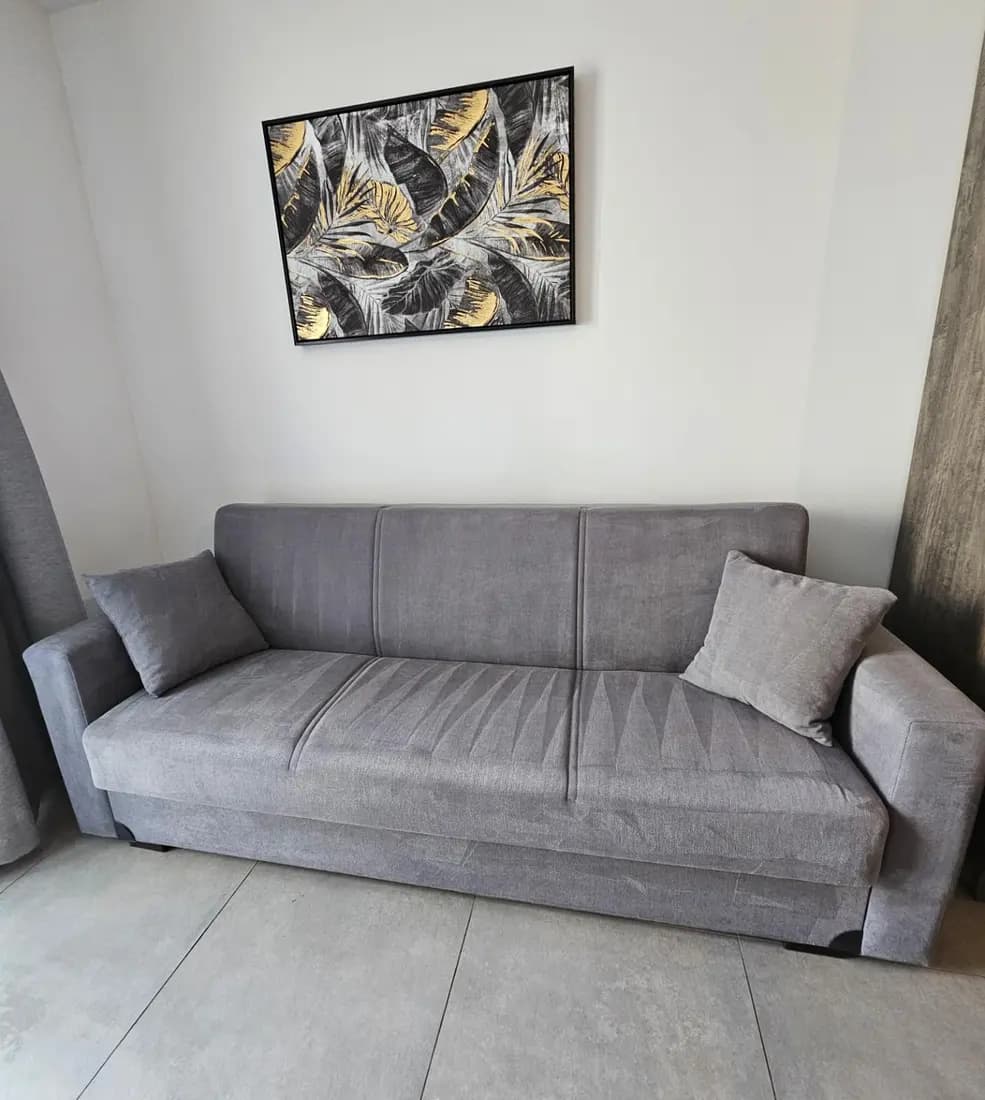 grey fabric sofa bed after professional cleaning by ARA Clean Malta