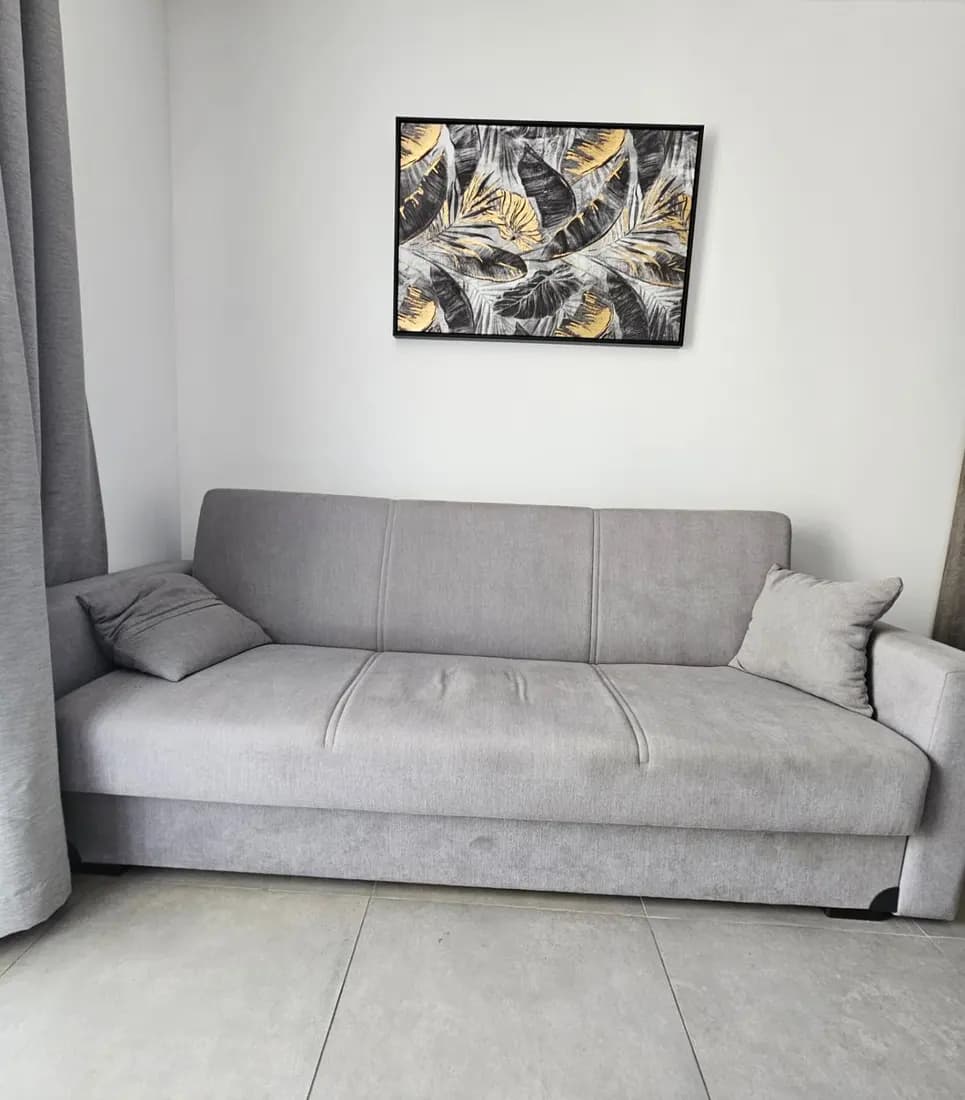 grey fabric sofa bed before cleaning by ARA Clean Malta