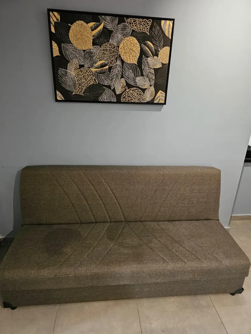 olive fabric sofa bed before cleaning by ARA Clean Malta