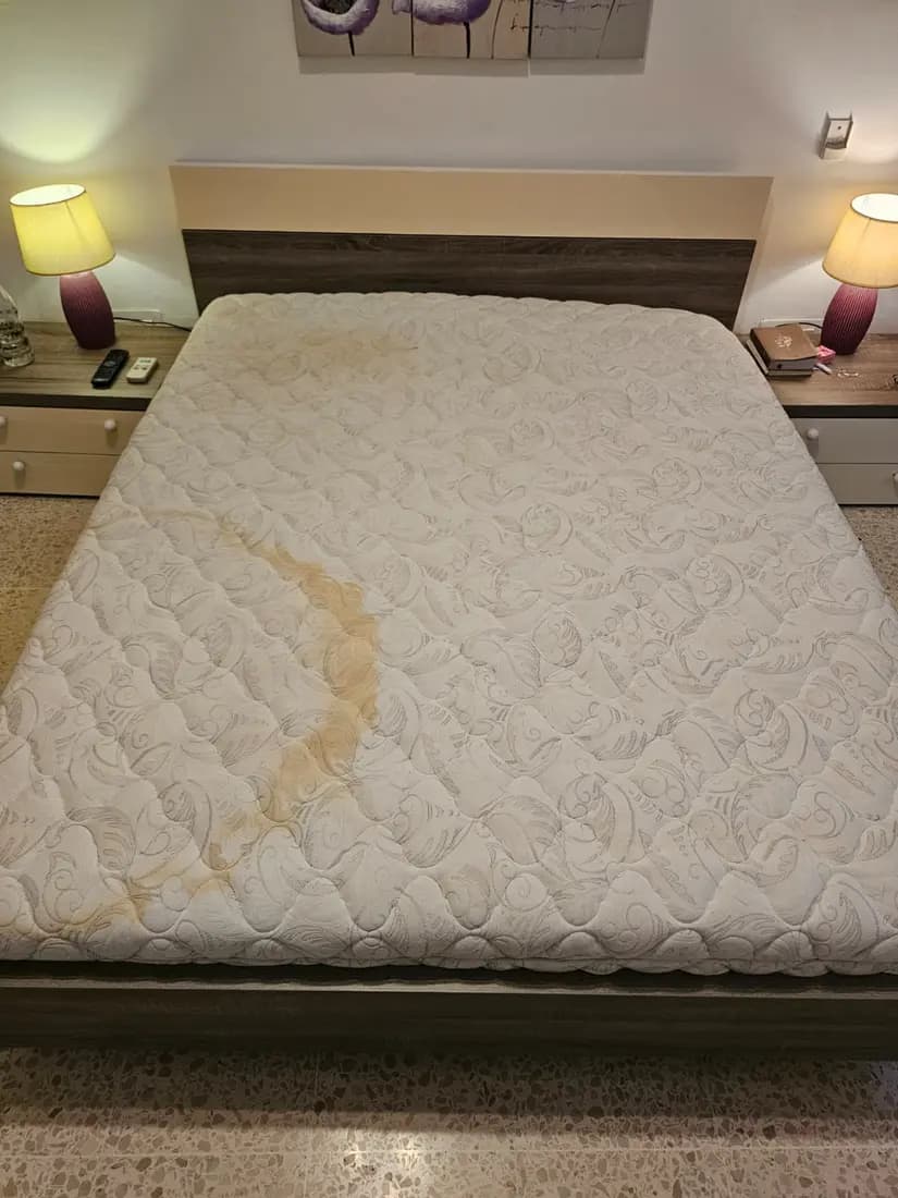 quilted mattress with a large stain before cleaning by ARA Clean Malta